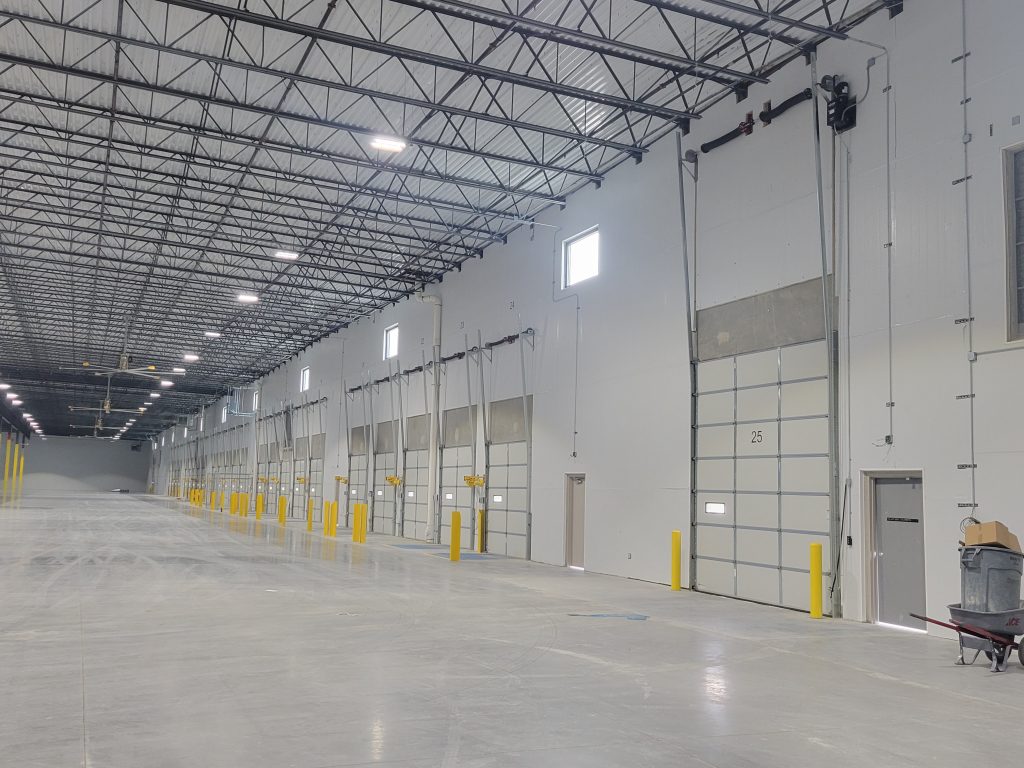 20240219_120932 Industrial building with newly installed doors - professional garage door services by Homeland Doors