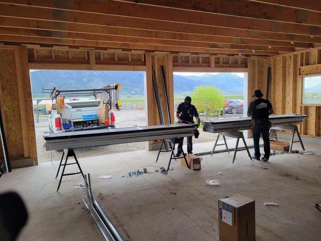 20240429_121504 Two employees performing garage door installation - part of our expert garage door services team at Homeland Doors